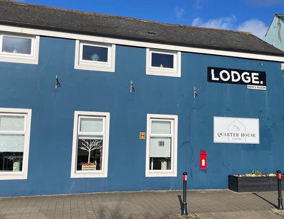 Blue painted traditional building housing Quarter House Coffee in Carrickfergus