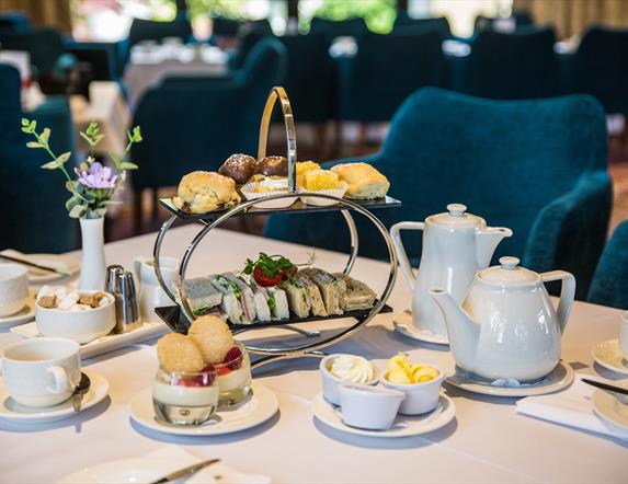 Afternoon tea in the Ross Park Hotel served on silver stand with white crockery and tablecloth