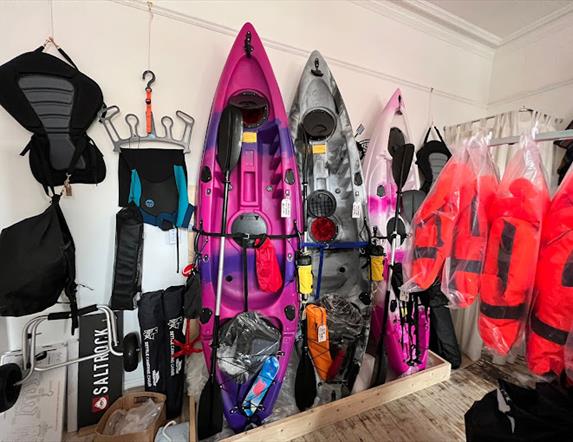 Kayaks and watersports equipment displayed in Salty Shack shop