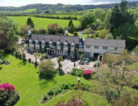 Aerial view of the house and grounds showing lawns to the front of the property