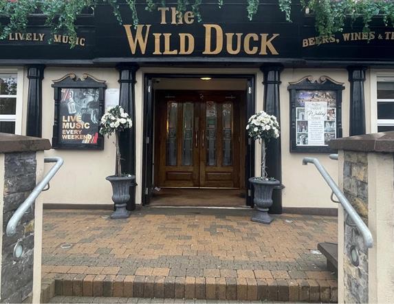 Exterior frontage of Wild Duck Inn in Portglenone with signs up for live music and great food.