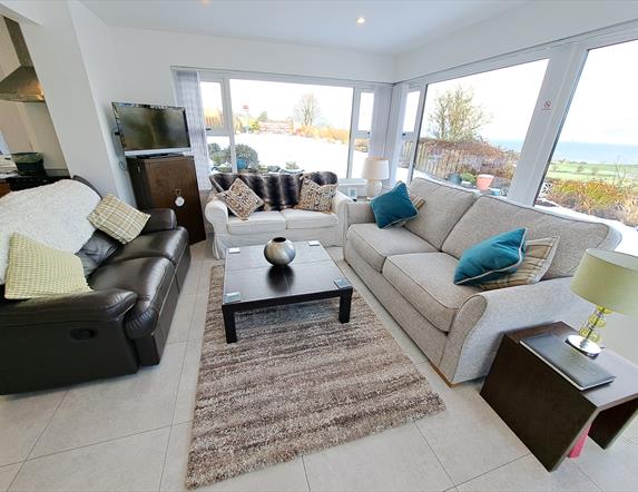 Sitting room area with surround windows and beautiful views.