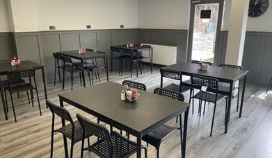 Interior of 7 Bistro / Cafe with grey floor and black tables and chairs