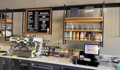 Serving counter at Mauds with hot drinks menus, coffee machines and ice cream containers