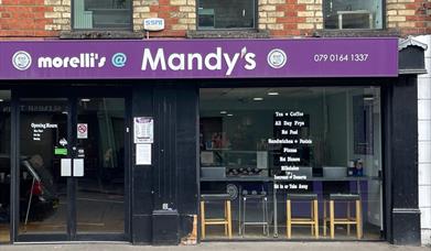 Shop front of Morelli's @ Mandy's with black frames and purple signage.