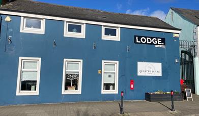 Blue painted traditional building housing Quarter House Coffee in Carrickfergus