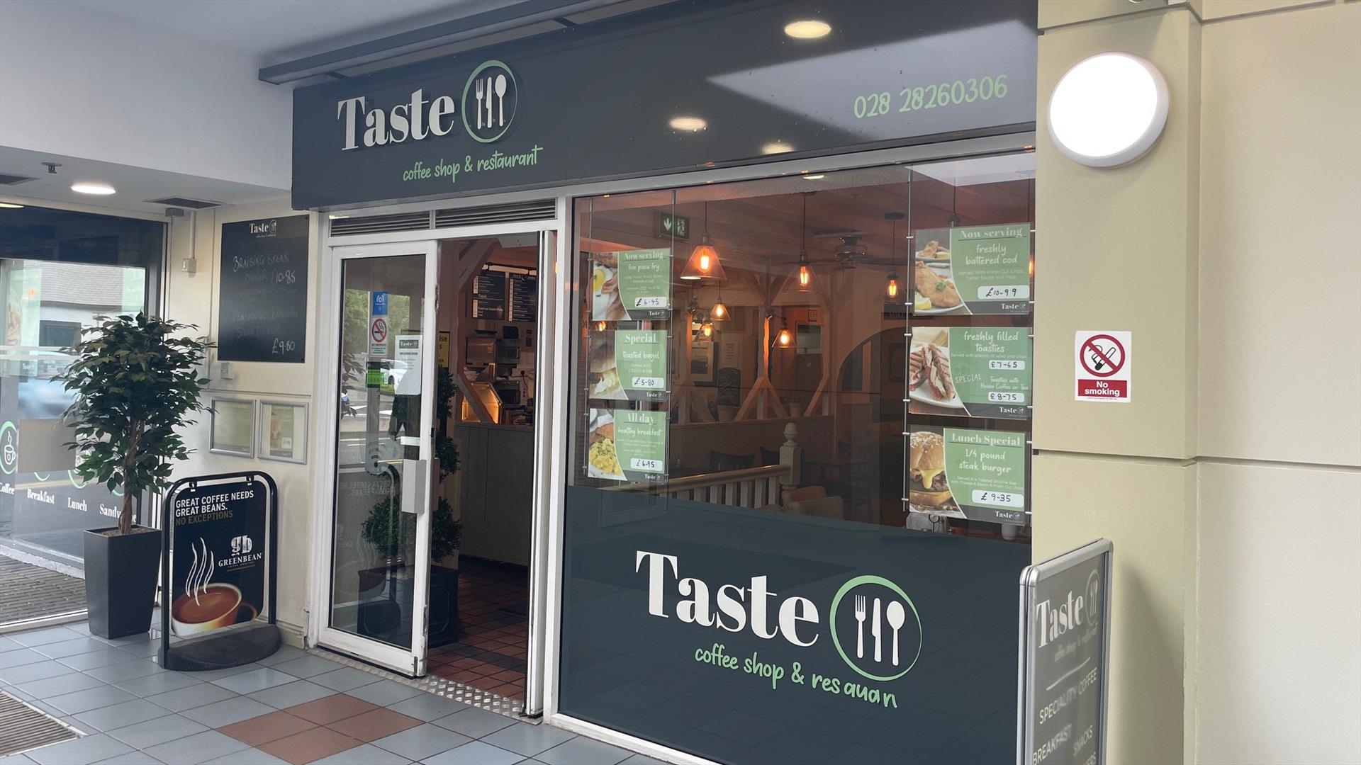 Grey and white exterior of Taste Coffee Shop & Restaurant