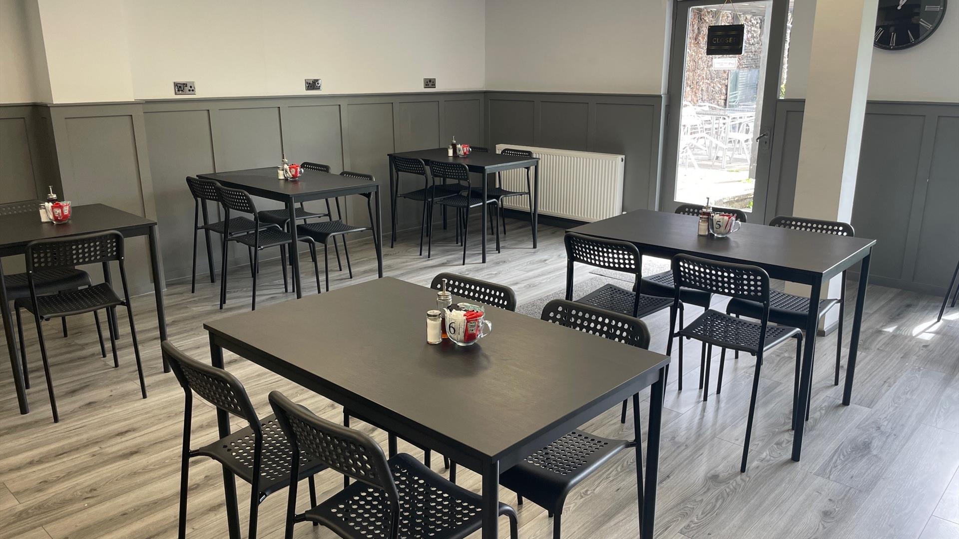 Interior of 7 Bistro / Cafe with grey floor and black tables and chairs