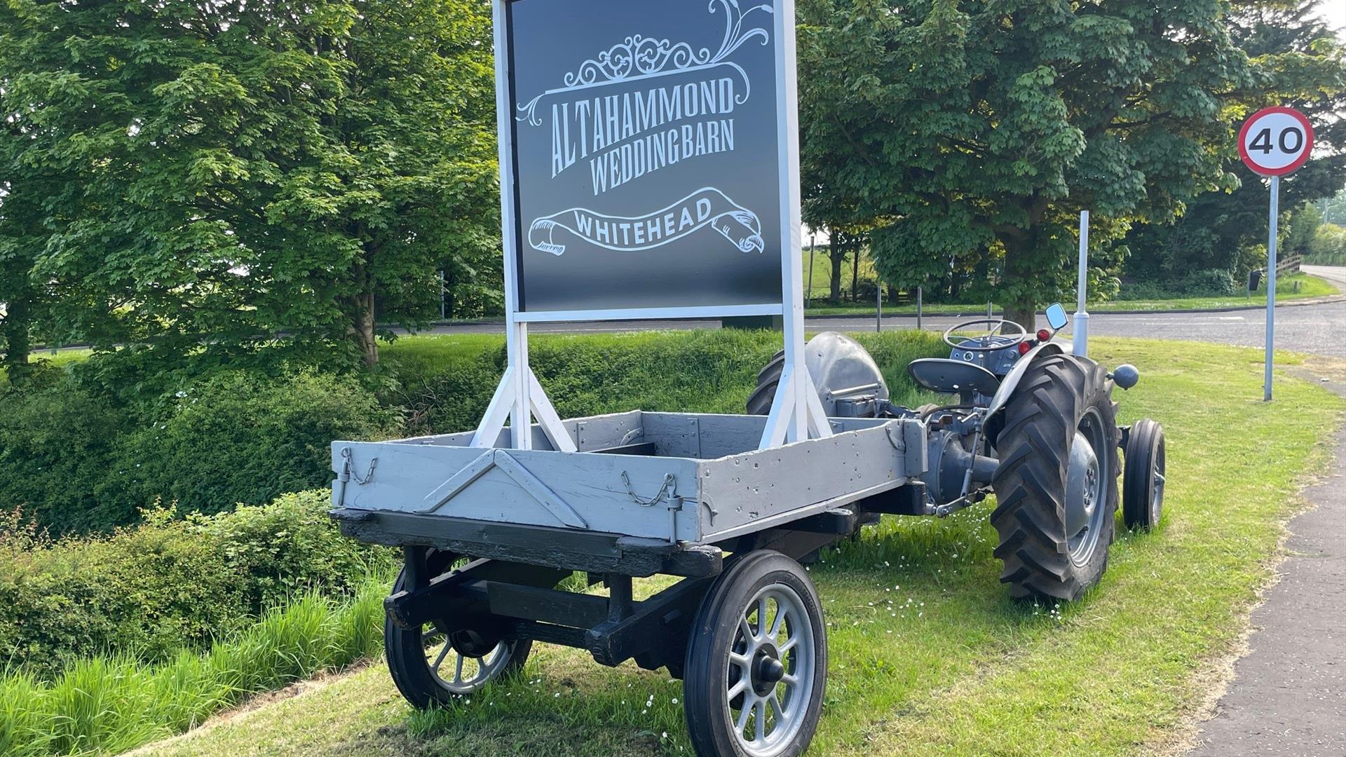 Vintage grey tractor with sign to rear stating Altahammond Wedding Barn