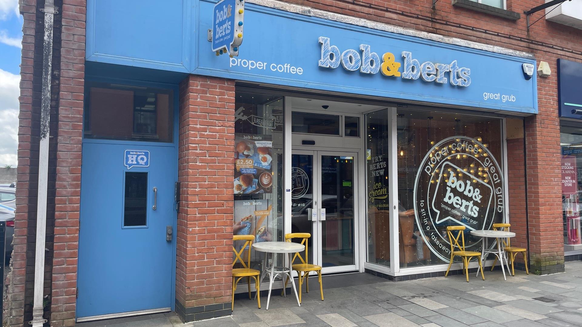 Exterior of Bob & Berts Coffee Shop with seats at front windows