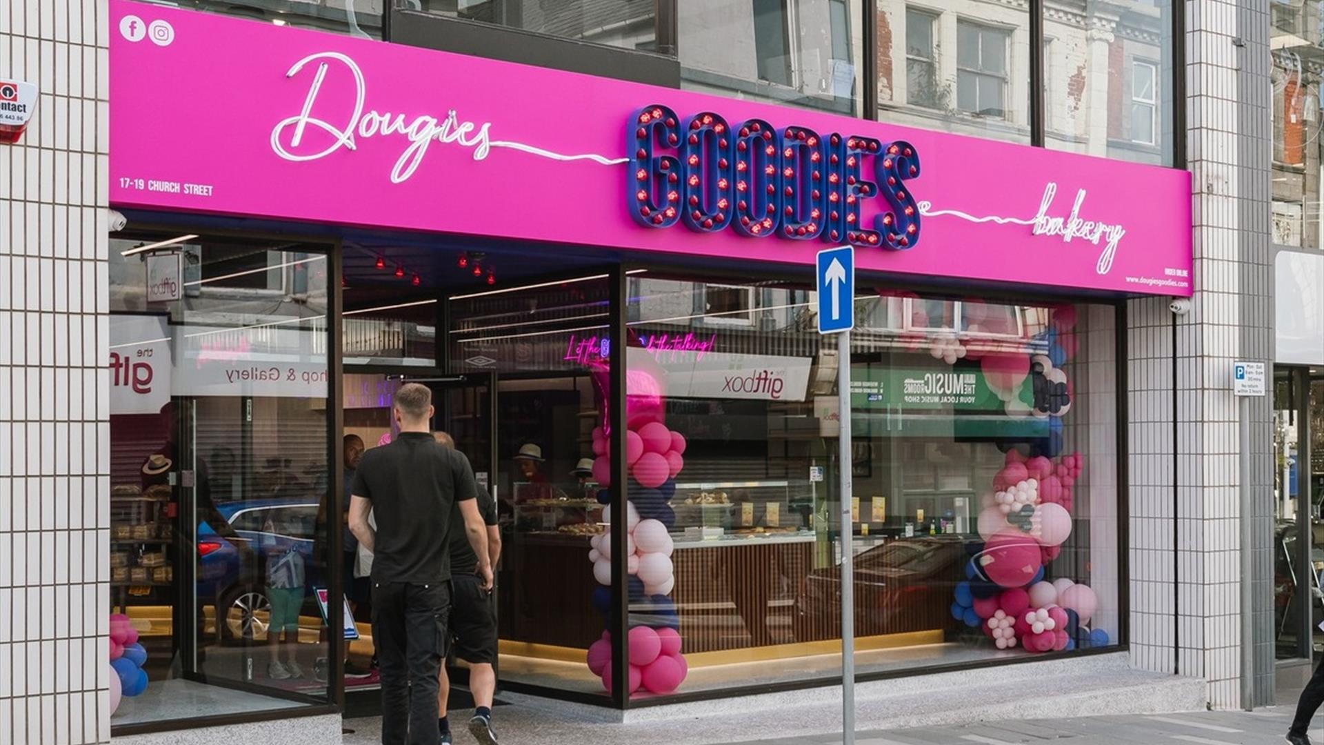 Exterior of Dougies Goodies Bakery in Ballymena with pink and purple signage