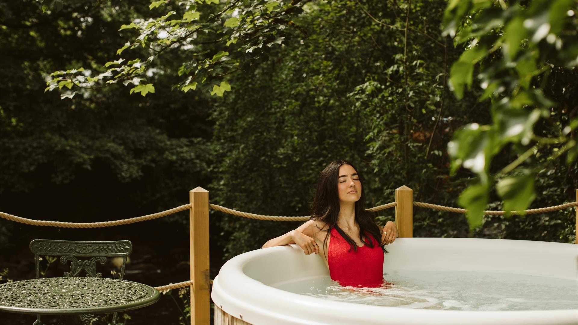 Galgorm Riverside Cottage with outdoor hot tub overlooking the river