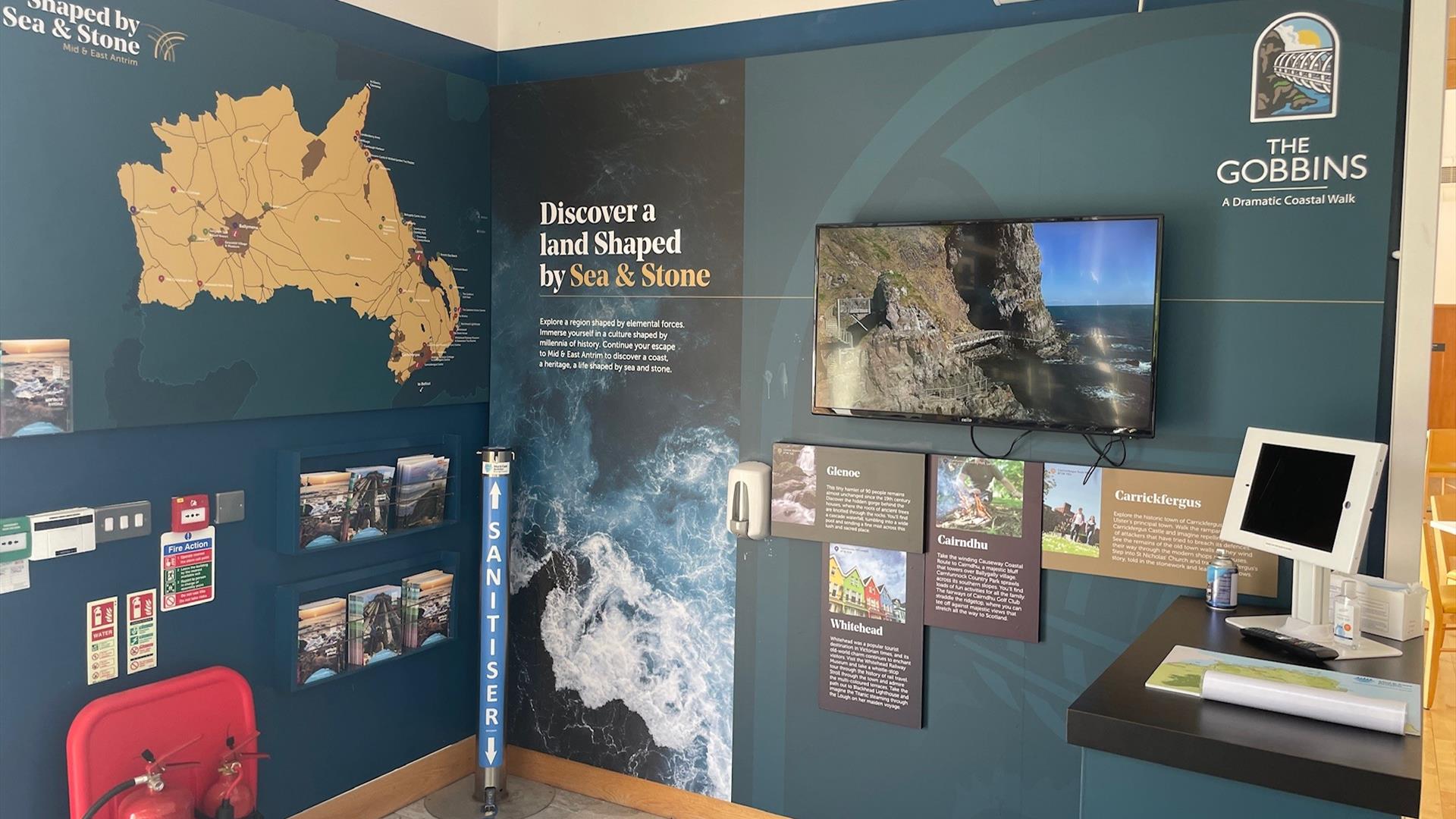 Visitor Information Point at The Gobbins Visitor Centre featuring map of Mid and East Antrim, leaflet display and video screen.