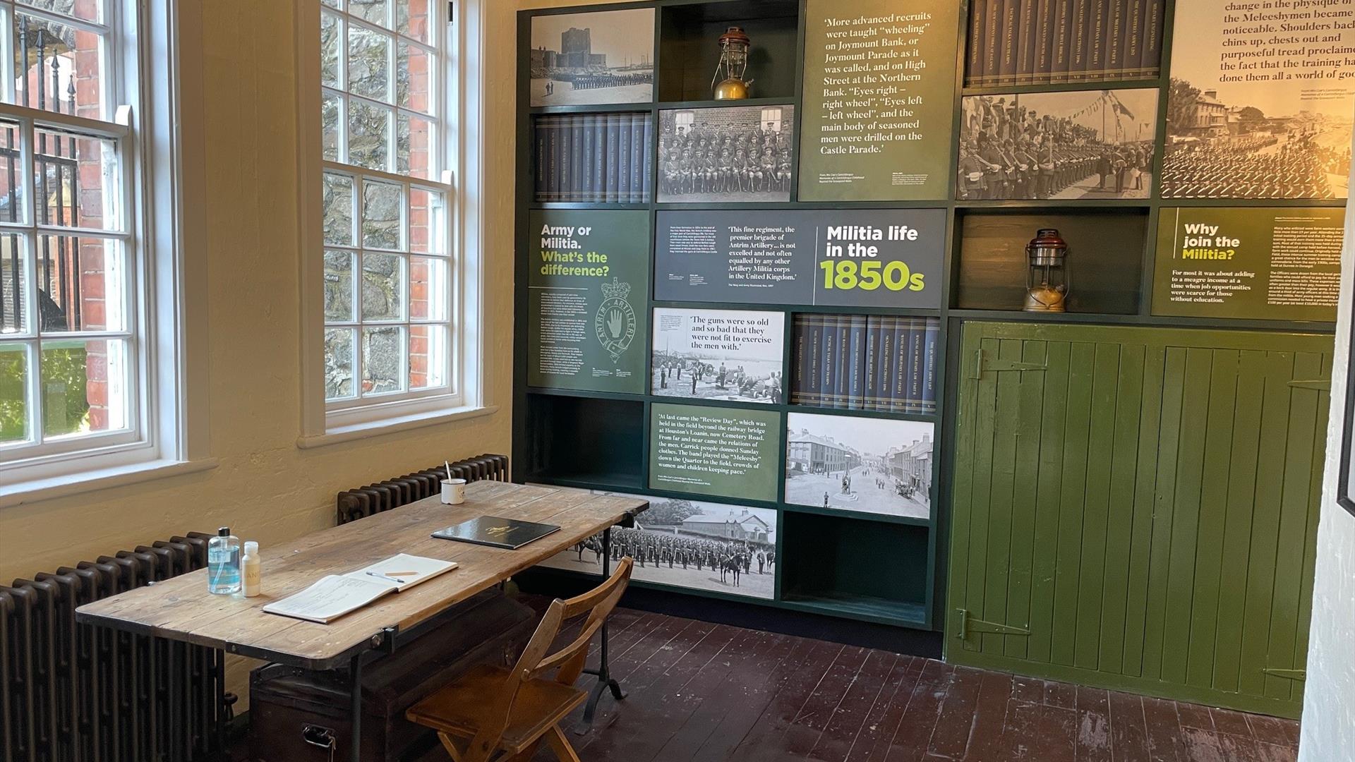 Interior of the Guard Room with information panels on wall and desk with Visitor Book