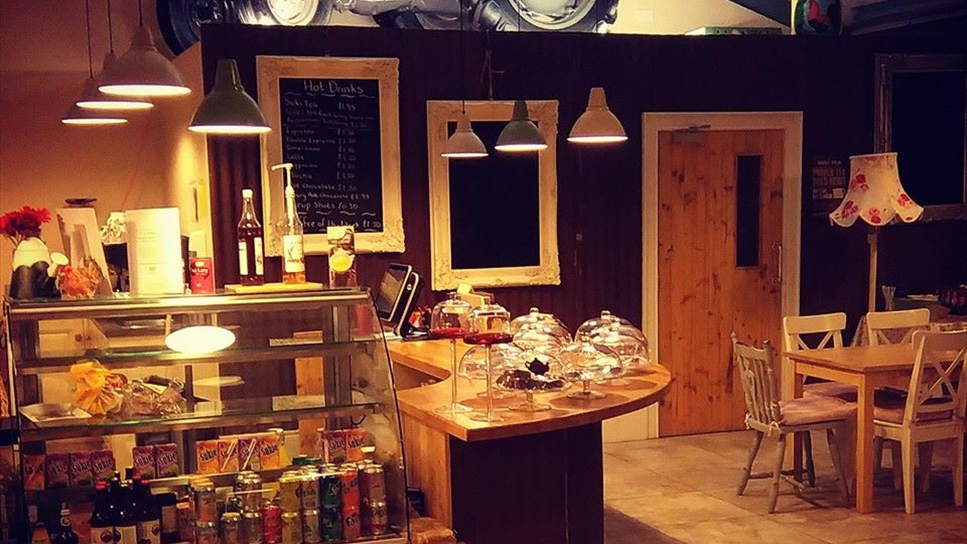 Serving counter in EJ's Country Kitchen in Hillstown, with drinks fridge to the front of the counter and display cases on the counter for scones, bake