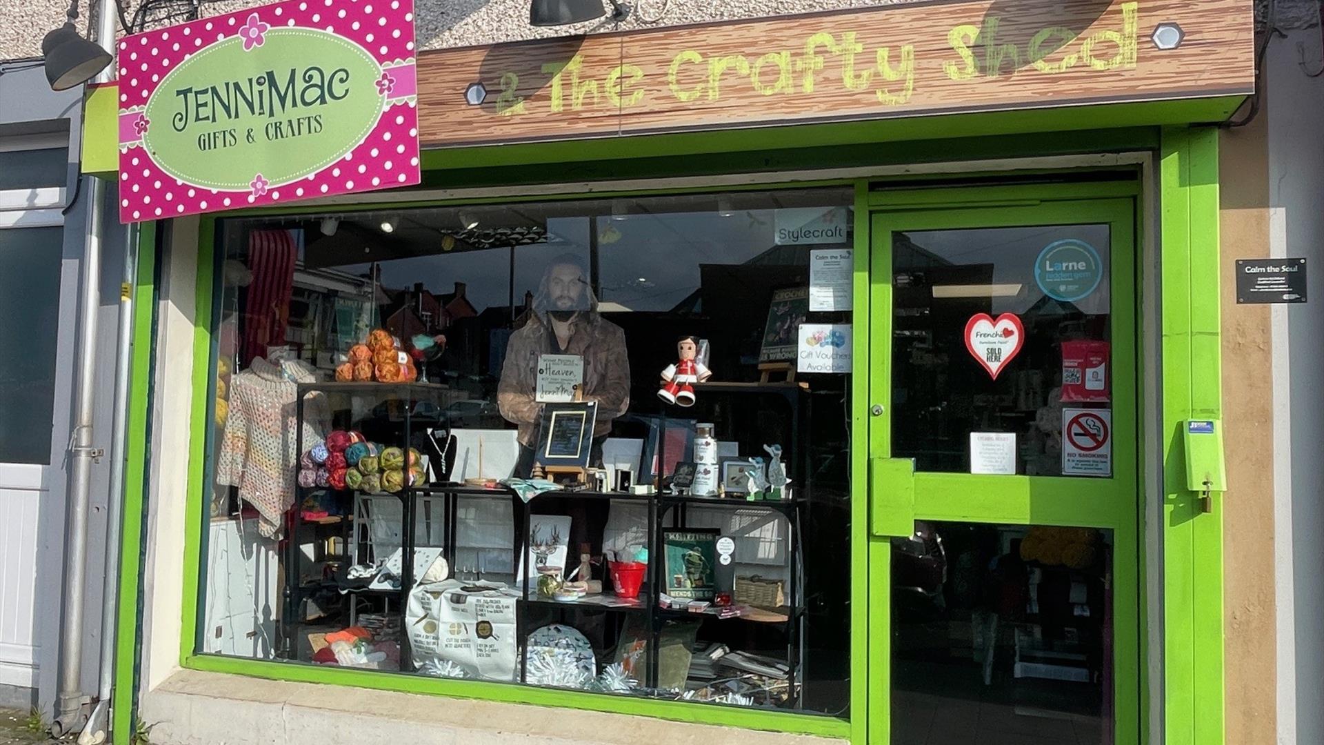 Green shop front of Jenni Mac Gifts & Crafts with window display of crafted items