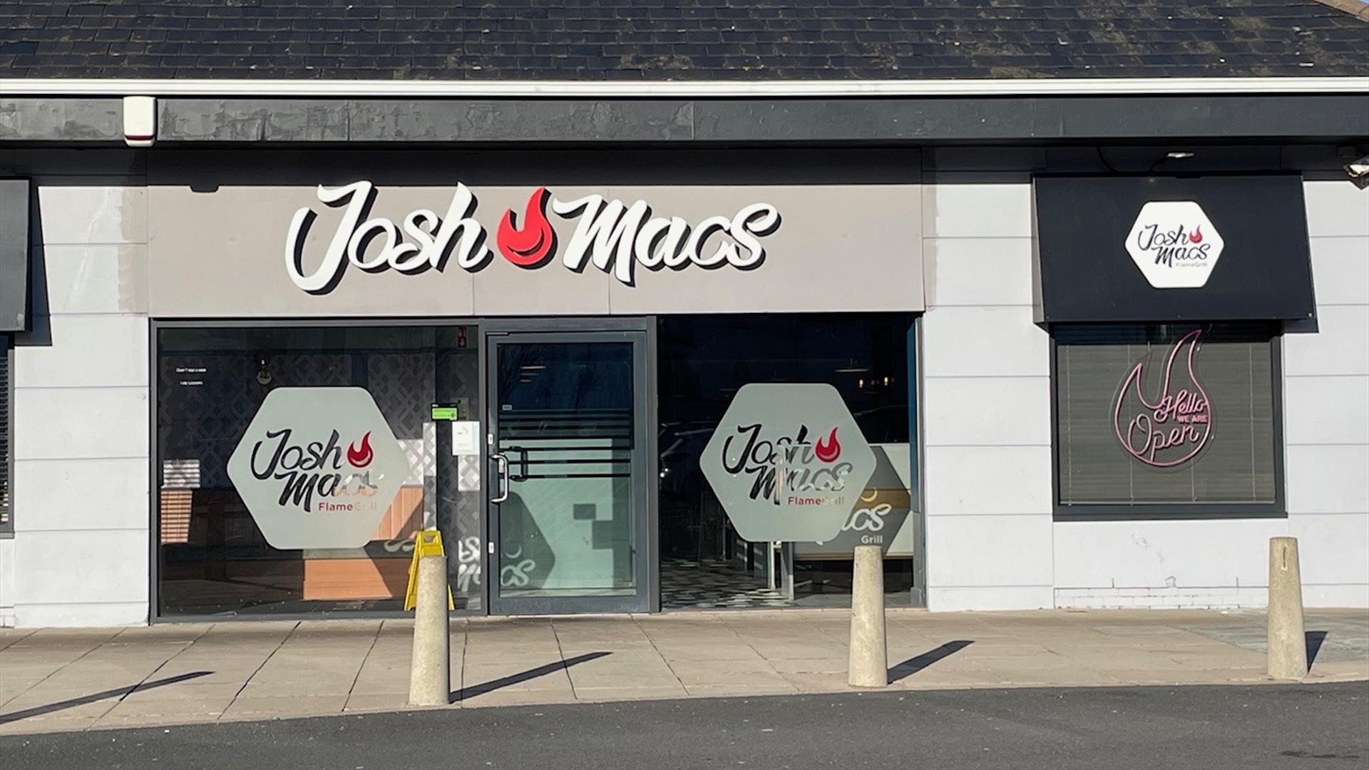 Josh Macs restaurant exterior with sign, large windows and door entrance,