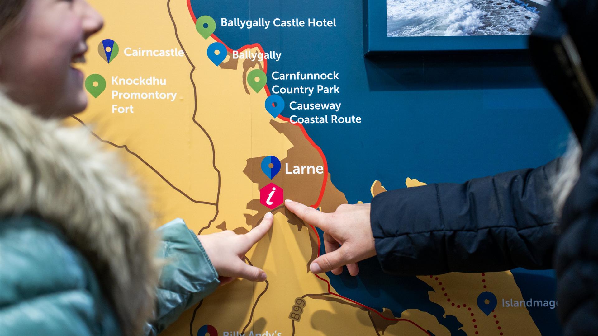 Exterior of the Book Nook in Larne with signage to promote Larne Post Office, Larne Visitor Information Point and MoneyGram