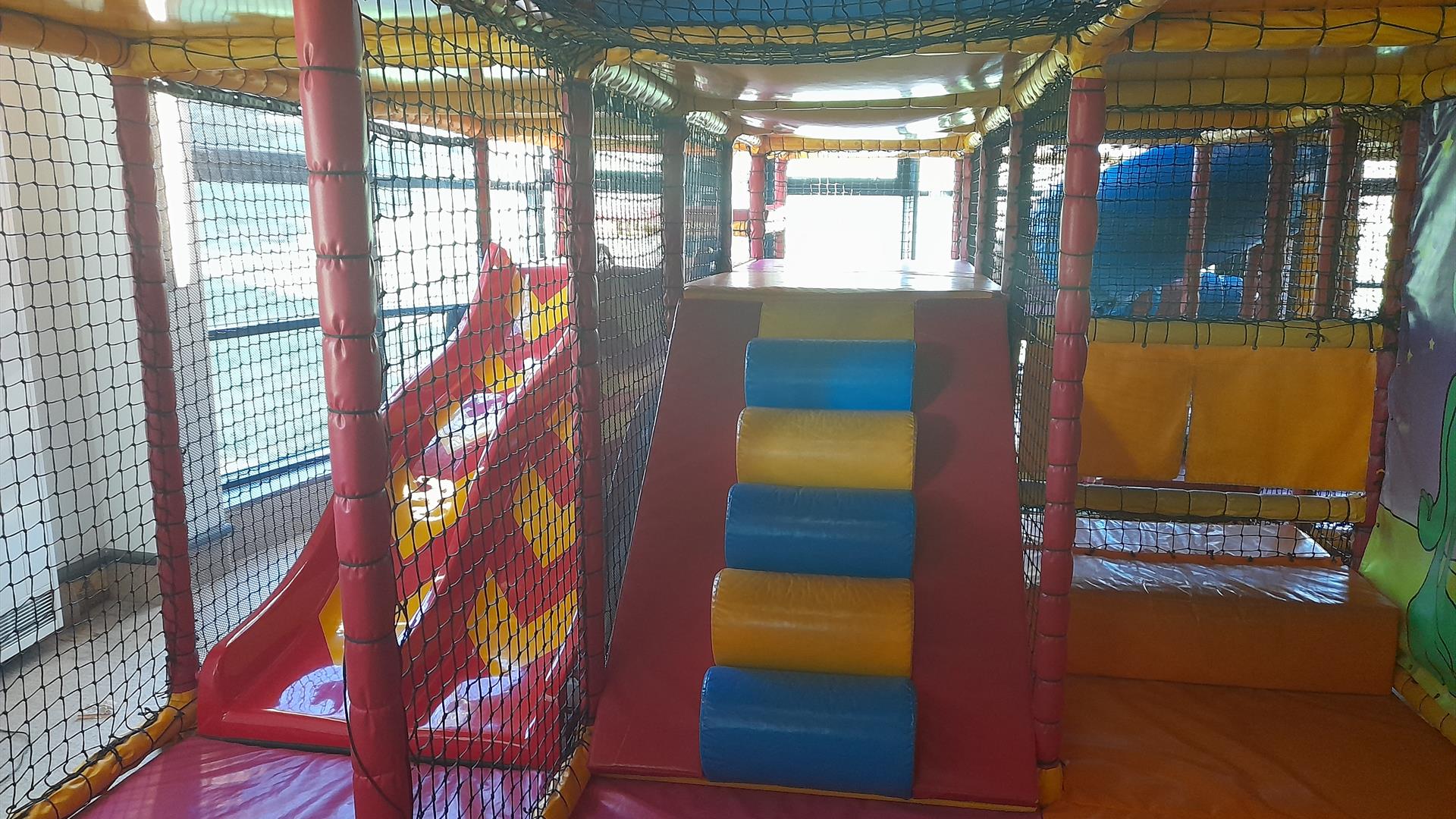 Ludo play area in Carrickfergus Amphitheatre featuring slides and climbing areas