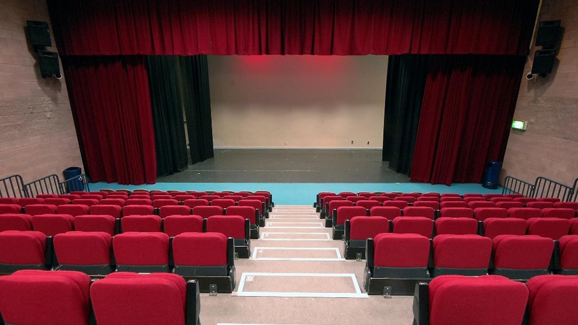 View from seating area of stage with curtains  in McNeill Theatre