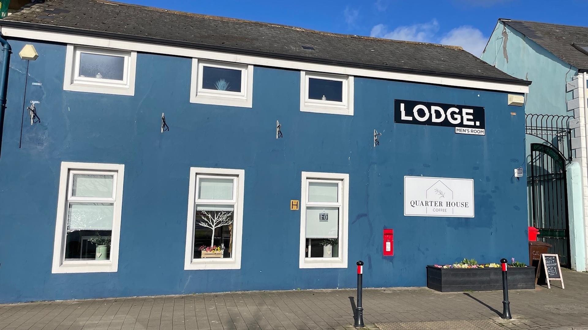 Blue painted traditional building housing Quarter House Coffee in Carrickfergus