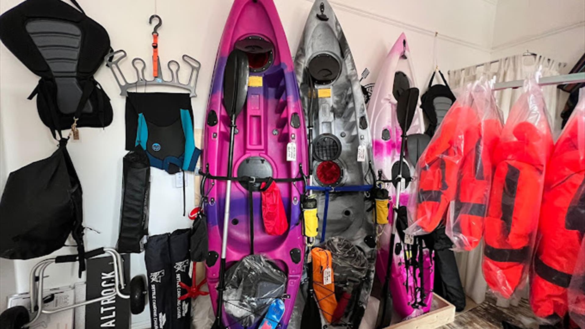 Kayaks and watersports equipment displayed in Salty Shack shop