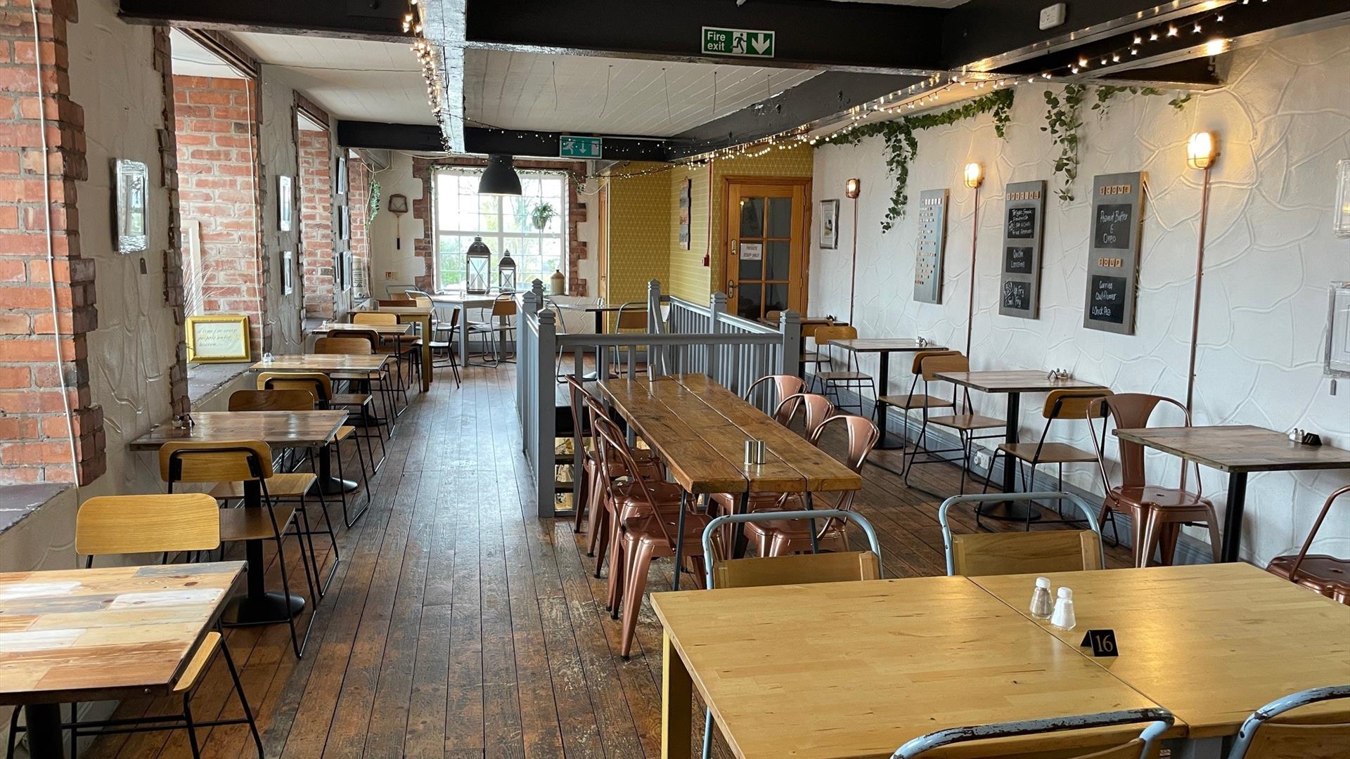 Interior of Season Coffee Shop with wooden flooring, wooden beams and wooden tables plus chairs.