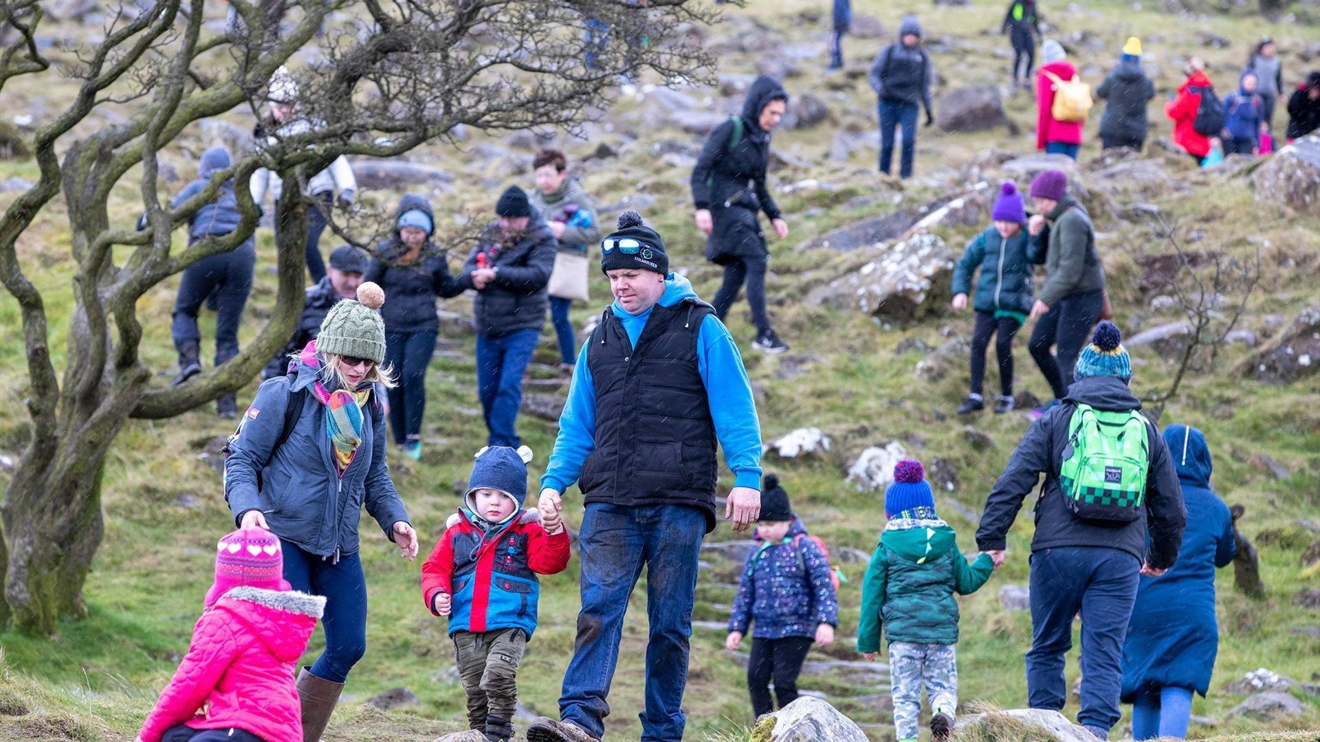 Crowds of people climbing Slemish on St Patricks Day