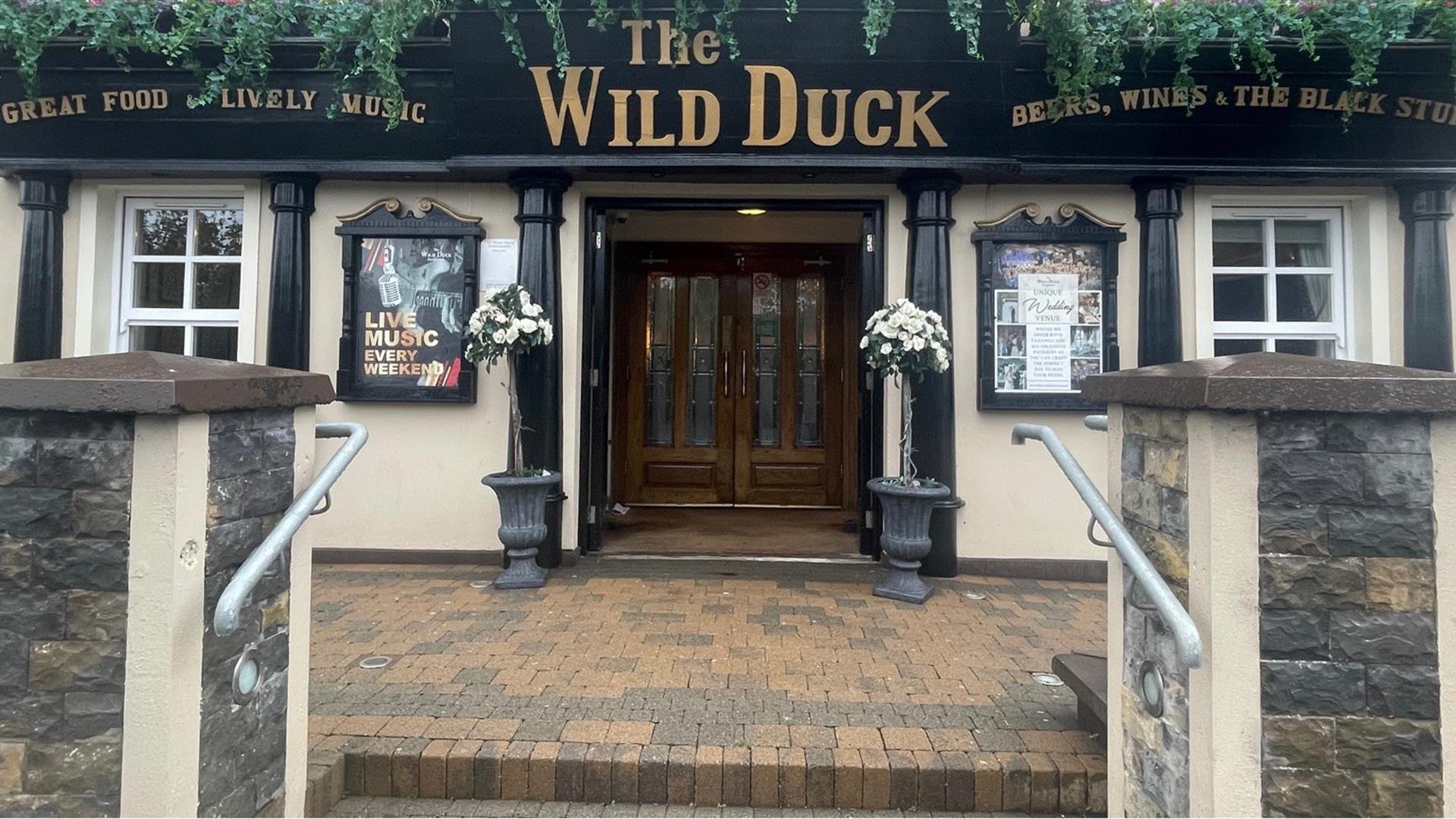 Exterior frontage of Wild Duck Inn in Portglenone with signs up for live music and great food.