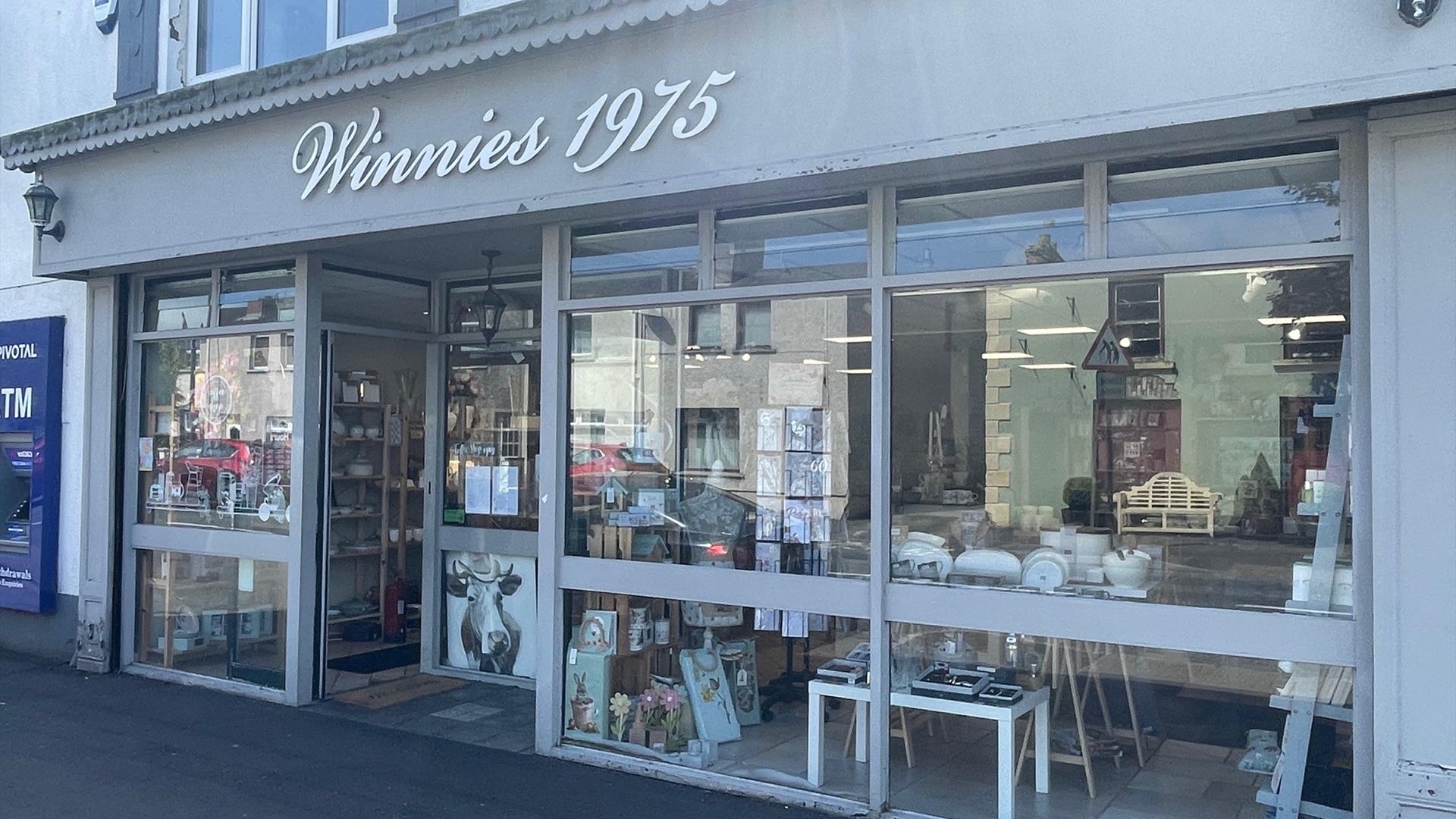 Grey exterior of Winnies 1975 with large window displays