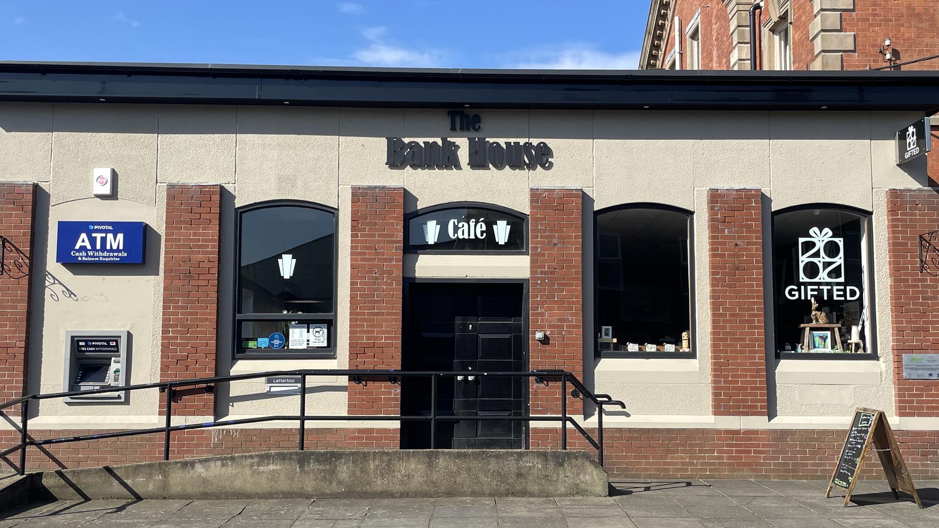 Building exterior of the red brick Bank House Cafe