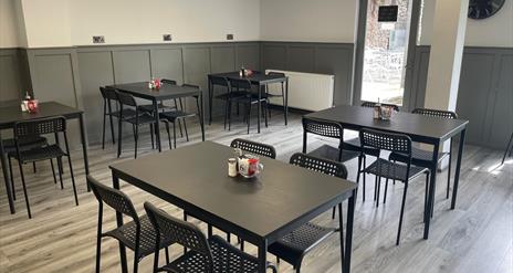 Interior of 7 Bistro / Cafe with grey floor and black tables and chairs