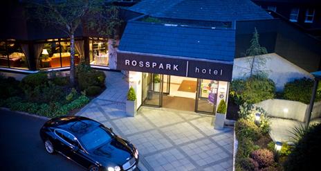 Night time exterior of entrance to Ross Park Hotel in Kells with car parked outside