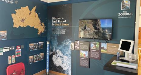 Visitor Information Point at The Gobbins Visitor Centre featuring map of Mid and East Antrim, leaflet display and video screen.