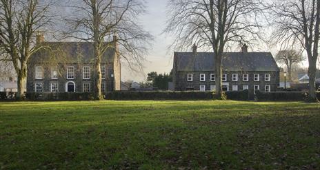 Buildings across green.