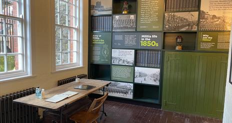 Interior of the Guard Room with information panels on wall and desk with Visitor Book