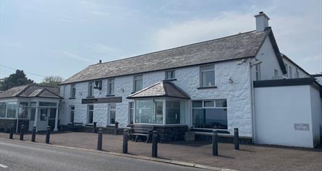 Whitewashed wall exterior of Halfway House Hotel in Ballygally