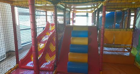 Ludo play area in Carrickfergus Amphitheatre featuring slides and climbing areas