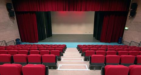 View from seating area of stage with curtains  in McNeill Theatre
