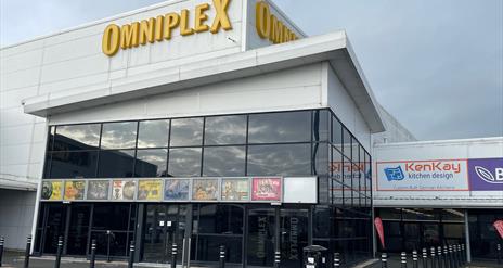 Omniplex Larne glass fronted exterior and entrance with poster signs displayed and large omniplex sign