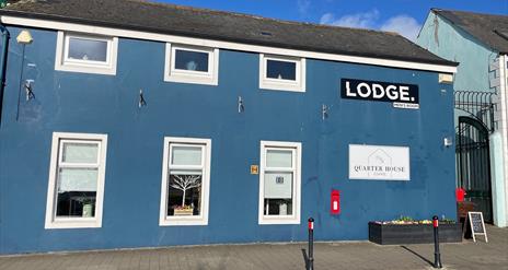 Blue painted traditional building housing Quarter House Coffee in Carrickfergus