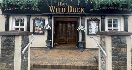 Exterior frontage of Wild Duck Inn in Portglenone with signs up for live music and great food.