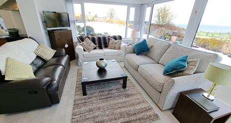 Sitting room area with surround windows and beautiful views.