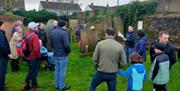 Alastair Donaghy leading a Ballymena Walking Tour with tour participants standing in a graveyard