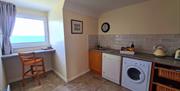 kitchen area with washing machine and a place to sit