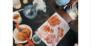 Aerial view of a table with various pigment related items and some ochre artwork