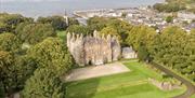 Aerial view of Glenarm Castle & Gardens with the ocean beyond.