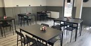 Interior of 7 Bistro / Cafe with grey floor and black tables and chairs