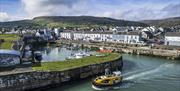 Curiosity boat leaving historical Carnlough harbour