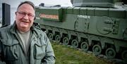 Adrian Hack, tour guide with Lead the Way Tours standing beside the Churchill Tank in Carrickfergus